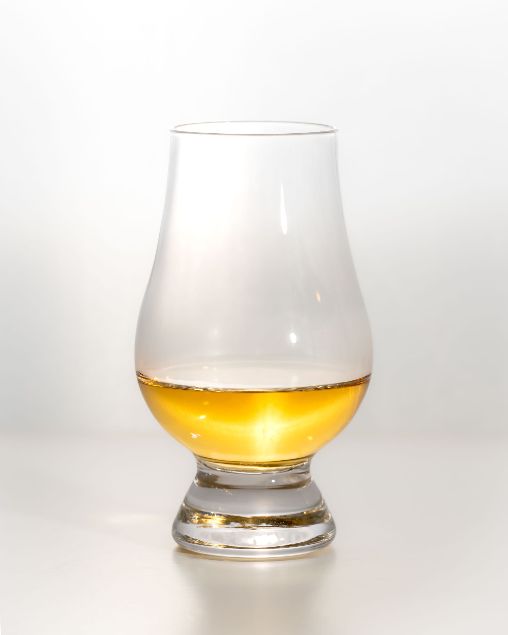 Bunnahabhain Stiùireadair dram, a light honey colour