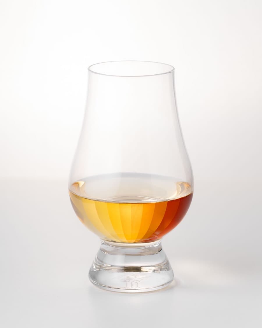 A Glencairn glass of whisky on a white background, the colour shown as a graded spectrum from pale gold to deep amber